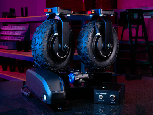 The image shows a set of motorized wheels attached to a control box, designed to be installed on an Inovativ Apollo cart for enhanced mobility.